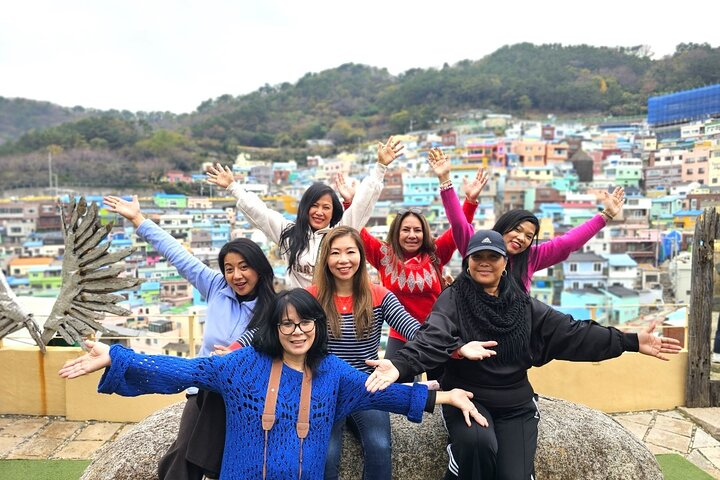 Experience the charm of Busan as you connect with fellow travelers surrounded by the colorful homes of Gamcheon Culture Village creating unforgettable memories in a unique setting.